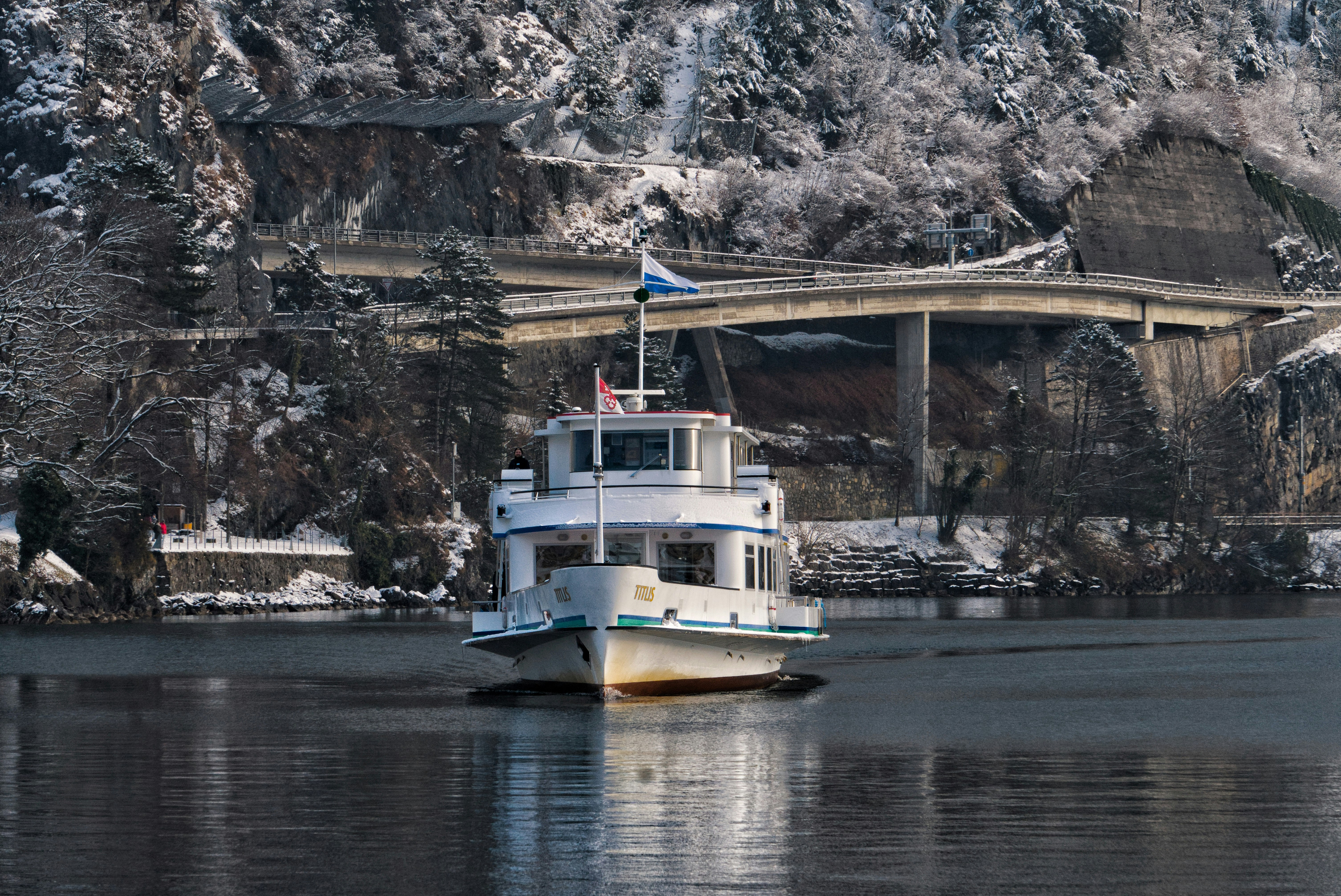white and blue boat on river during daytime